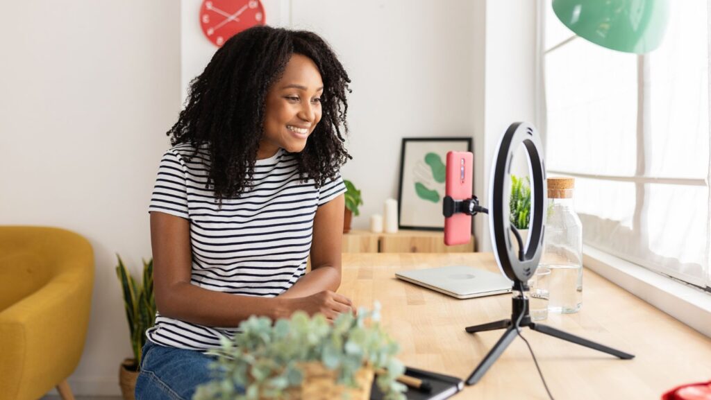 young woman creating content in a bright workspace.